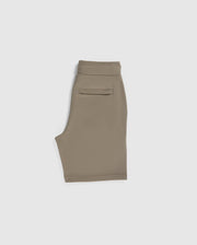 This image shows a pair of beige KIDS FRENCH TERRY SHORTS - B0R829ARFT by Psycho Bunny folded in half and lying flat against a white background. The shorts have a waistband, a rear pocket on the right side, and an embroidered Bunny logo near the hem. The fabric appears smooth and comfortable.
