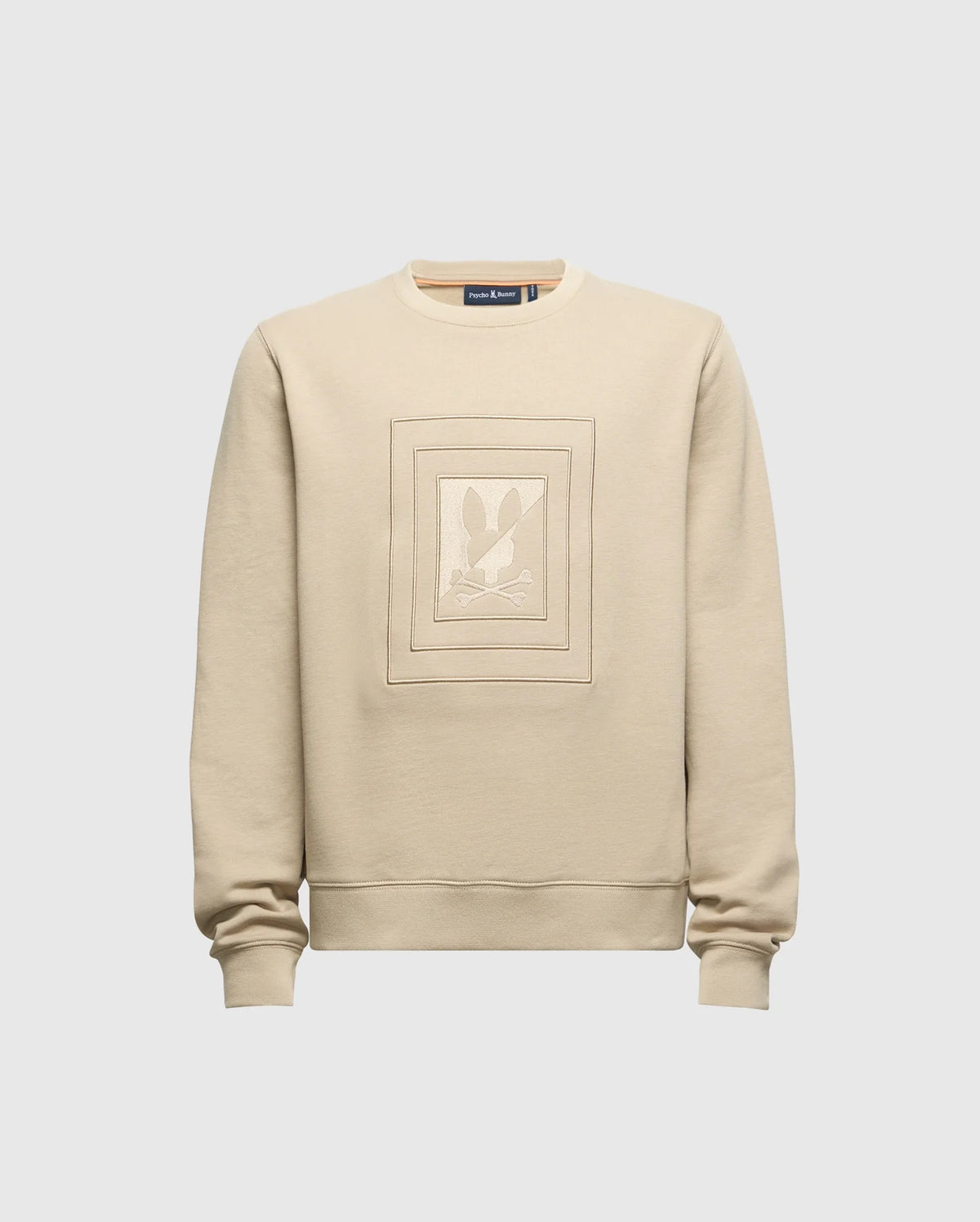 The KIDS OAK CITY CREW NECK SWEATSHIRT - B0S274E200 by Psycho Bunny is a beige, lightweight garment with long sleeves. It showcases an embossed rectangular design featuring a stylized rabbit against a plain light grey background, echoing the popular Psycho Bunny style. This piece is perfect for adding a charming touch to any child's wardrobe.