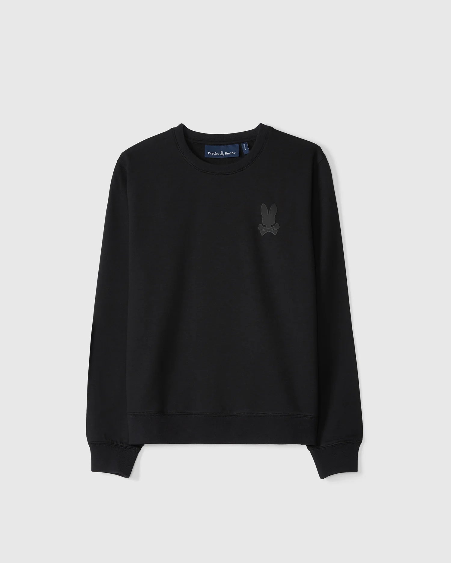 The KIDS HOUSTON FRENCH TERRY CREWNECK by Psycho Bunny is a black pullover sweatshirt made from premium cotton fabric. It features a subtle embossed bunny graphic on the upper left chest and has ribbed cuffs along with a ribbed hem, all set against a light gray background.