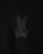 The KIDS HOUSTON FRENCH TERRY CREWNECK - B0S462C200 by Psycho Bunny features a black background with a minimalist, monochromatic bunny head design alongside crossed bones, giving it a pirate skull and crossbones vibe. Made from premium cotton fabric, this lightweight piece brings an edgy elegance to your collection.