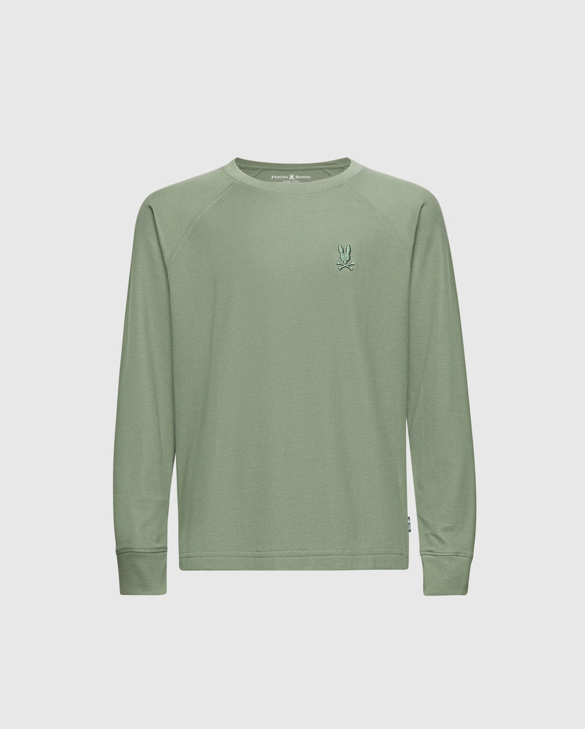 The Psycho Bunny KIDS TAYLOR PIQUE LONG SLEEVE TEE - B0T580F200 is a light green tee featuring an embroidered Bunny logo on the chest. With a round neckline, it's crafted from luxurious Pima cotton, offering a smooth texture and casual, simple design.