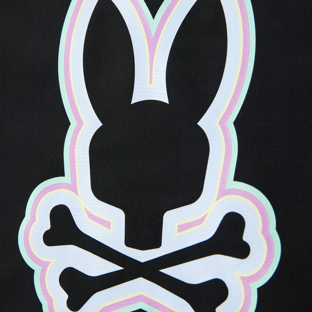 A close-up image of a stylized white rabbit head logo with crossed bones behind it, outlined in neon pink and green on a Psycho Bunny Kids San Leon Anti-UV Rashguard - B0T645C200 with UPF 50+ protection against a black background.