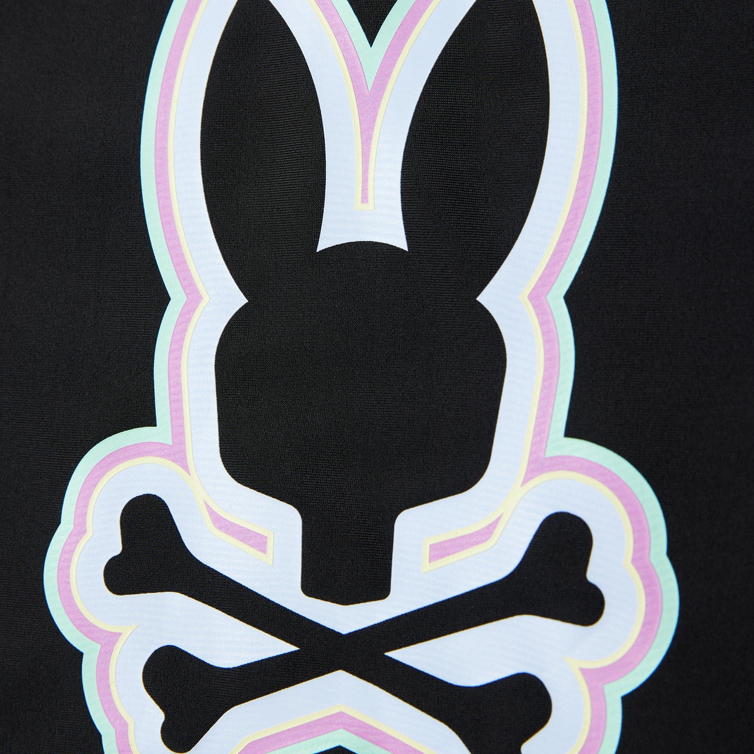 A close-up image of a stylized white rabbit head logo with crossed bones behind it, outlined in neon pink and green on a Psycho Bunny Kids San Leon Anti-UV Rashguard - B0T645C200 with UPF 50+ protection against a black background.