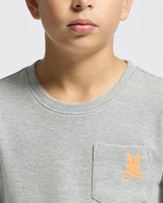 A person wearing a gray textured KIDS VAL WAFFLE LONG SLEEVE TEE (Product Code: B0T672E200) by Psycho Bunny, featuring an orange embroidered bunny logo on the chest pocket. The background is plain white.