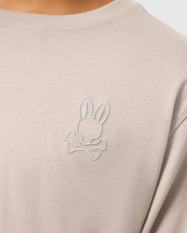 Product Description: The KIDS ALBERTON LONG SLEEVE TEE from Psycho Bunny features a close-up of an embroidered rabbit head and crossbones design on the left chest. Made from soft Pima cotton, this beige regular fit tee combines comfort and style effortlessly.