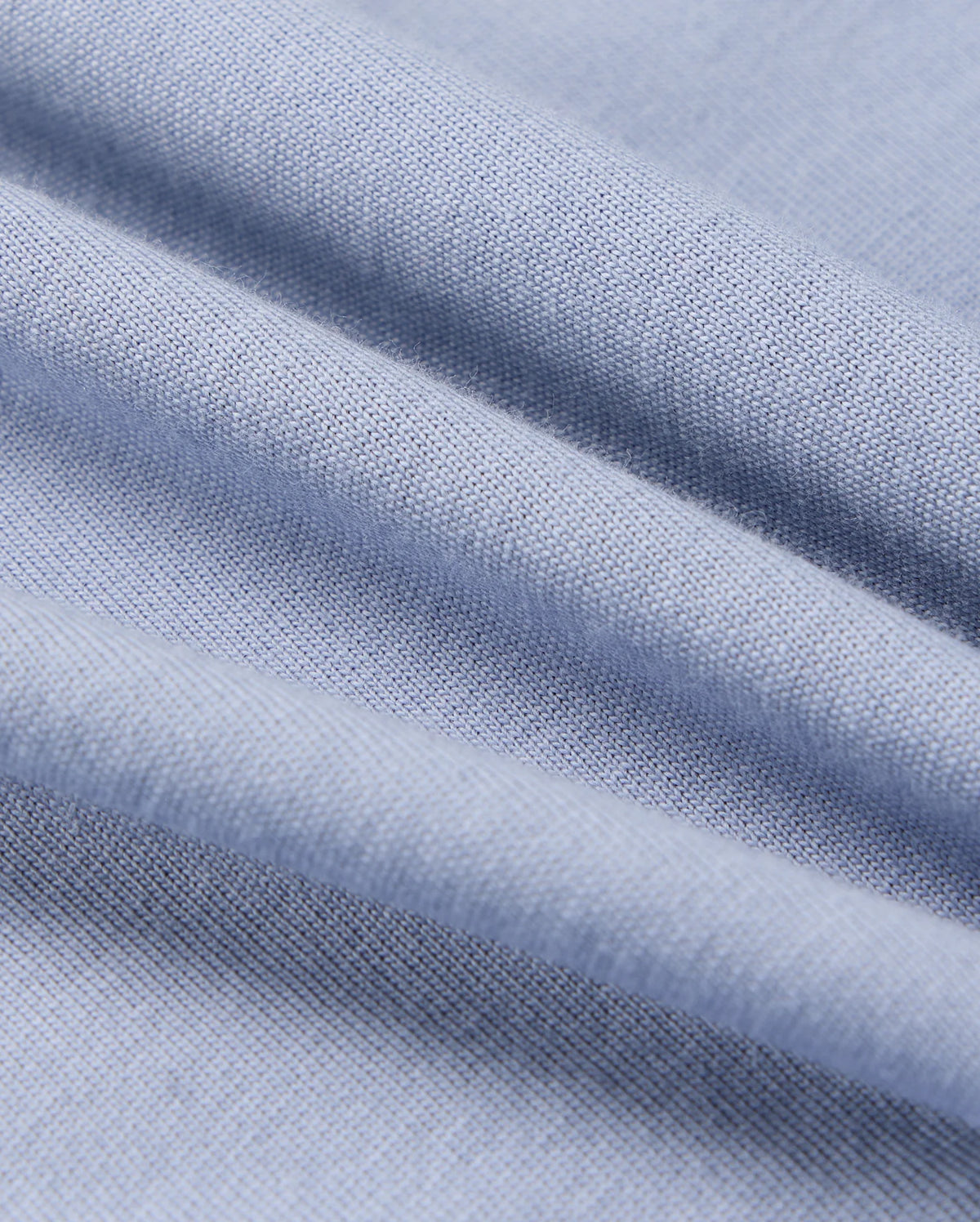 The Psycho Bunny KIDS MONROE LONG SLEEVE TEE (B0T975D200) features light blue, soft pima cotton with visible weave texture, offering gentle folds and a cozy style for versatile use.