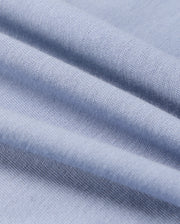 The Psycho Bunny KIDS MONROE LONG SLEEVE TEE (B0T975D200) features light blue, soft pima cotton with visible weave texture, offering gentle folds and a cozy style for versatile use.
