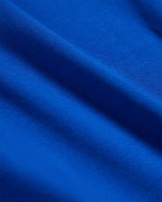 Close-up of a blue fabric with visible texture and gentle folds, creating a sense of depth and softness. Made from luxurious Pima cotton, the lighting highlights the rich color and smooth surface of the KIDS CLASSIC CREW NECK TEE - B0U014CRPC by Psycho Bunny.