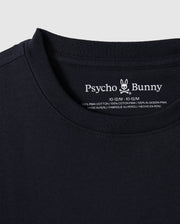 Close-up of the KIDS EMBROIDERED CLASSIC TEE - B0U020AR00 in black, featuring the Psycho Bunny brand logo and text on the inside neck area. It boasts an embroidered chest bunny, and the label confirms it's made of 100% Peruvian Pima cotton, manufactured in Peru.