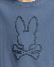 The KIDS MONARC FRONT BUNNY GRAPHIC TEE - B0U211E200 by Psycho Bunny showcases a blue shirt with an embossed Monarc Front Bunny design above crossbones. Crafted from soft Pima cotton, the simple yet stylized design adds a playful, edgy touch to the garment.