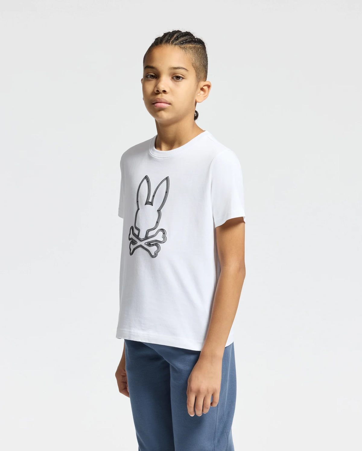 The image shows a white short-sleeved t-shirt with a black Psycho Bunny logo on the left chest.