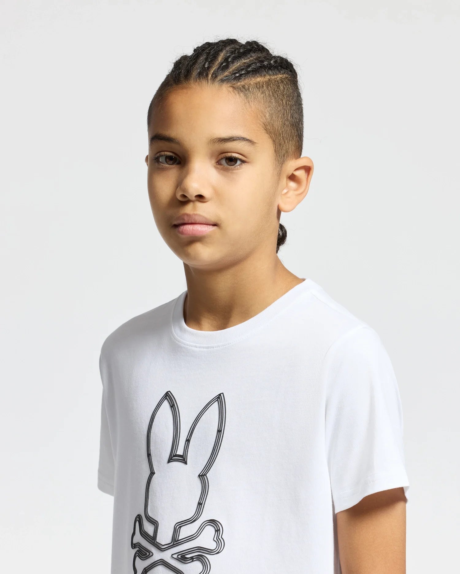 The image shows a white short-sleeved t-shirt with a black Psycho Bunny logo on the left chest.