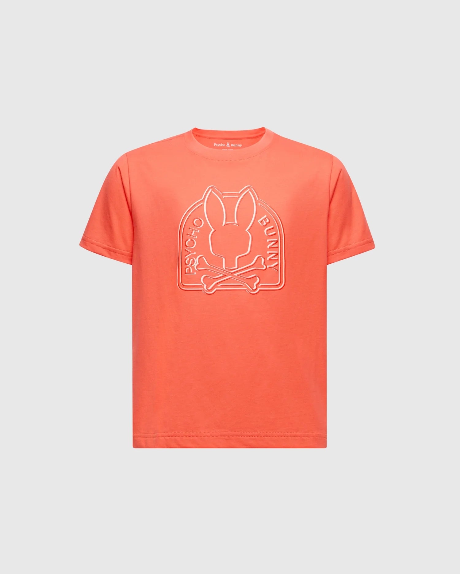The KIDS MELBOURNE GRAPHIC TEE offers a bold orange color with a unique bunny and crossbones design, branded "Psycho Bunny" text, crafted from soft Peruvian Pima cotton for comfort. It features a classic crew neck and short sleeves.