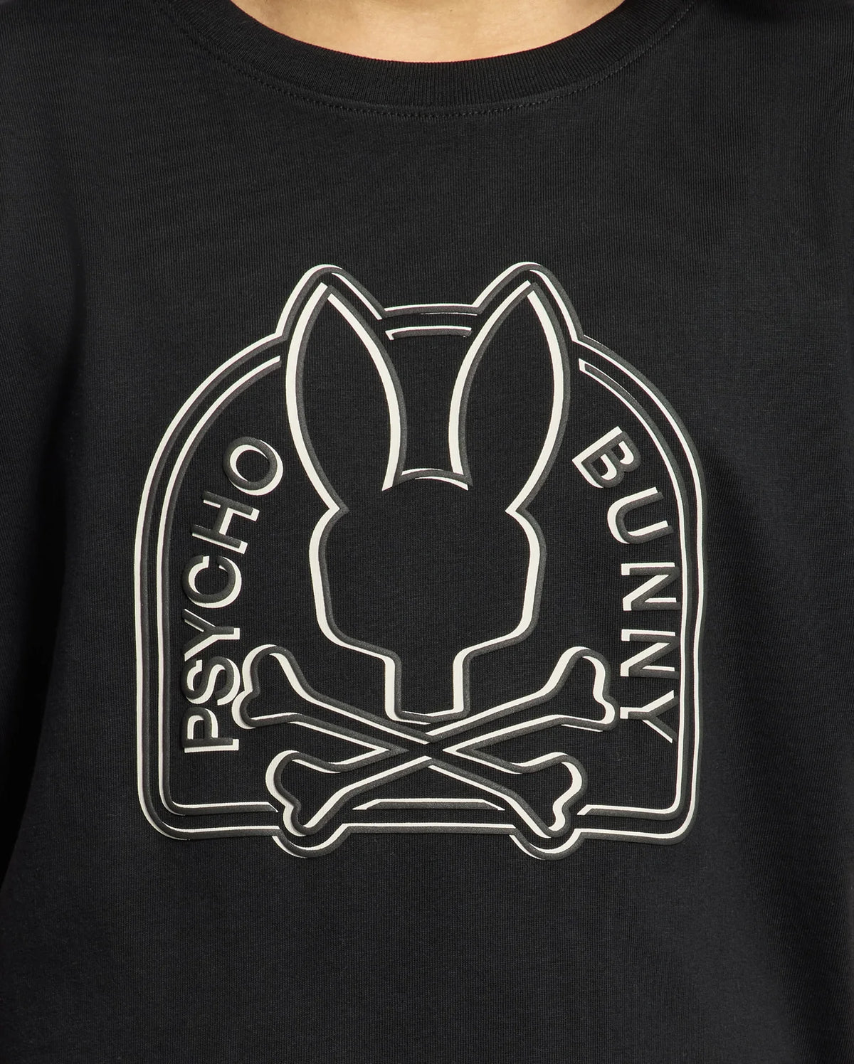 The KIDS MELBOURNE GRAPHIC TEE by Psycho Bunny, crafted from soft Pima cotton in black, showcases a stylized Bunny graphic with a bunny silhouette above crossed bones and "Psycho Bunny" elegantly displayed on either side.