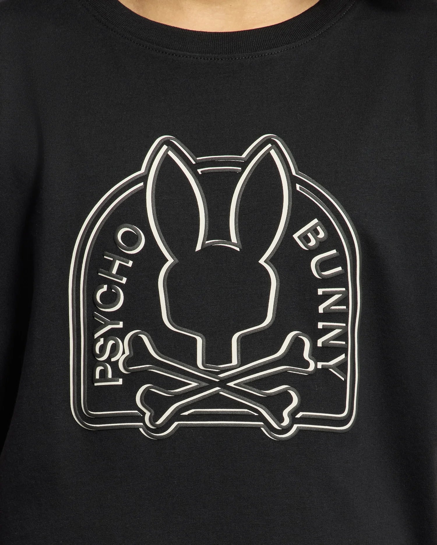 The KIDS MELBOURNE GRAPHIC TEE by Psycho Bunny, crafted from soft Pima cotton in black, showcases a stylized Bunny graphic with a bunny silhouette above crossed bones and "Psycho Bunny" elegantly displayed on either side.
