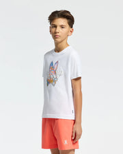 White jersey t-shirt with a large, vibrant Psycho Bunny skull and text graphic on the chest, paired with coral classic fit shorts featuring a small embroidered white bunny skull logo on the left leg.