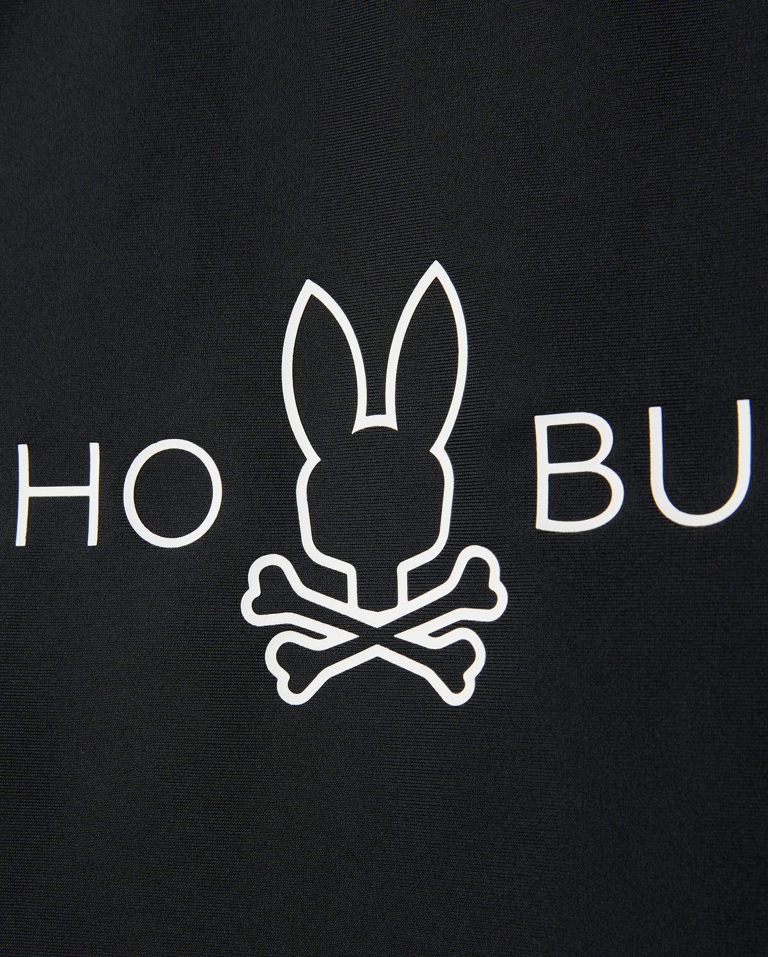 A black background features a white minimalist graphic of a bunny head with crossed bones, mimicking a skull and crossbones. The letters "HO" are partially visible to the left of the bunny, and "BU" to the right. This design is perfect for a Psycho Bunny KIDS SHORT SLEEVE ANTI-UV RASHGUARD - B0U558C200 offering UPF 50+ protection.