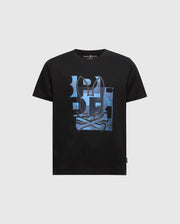 The Psycho Bunny KIDS ZEALAND GRAPHIC TEE, product B0U604F200, is a black Pima cotton kids' shirt featuring a skull and crossbones print with blue abstract shapes and a playful hint of the bunny logo on a light grey background.