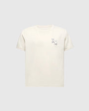 The KIDS ELLIOT FRONT BACK GRAPHIC TEE by Psycho Bunny features a subtle water-based line drawing of Mickey Mouse on the left chest. Made from soft Pima cotton, it comes in beige with a plain gray background.