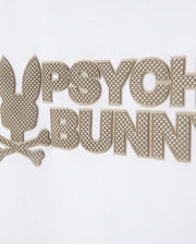 Close-up of the KIDS MELVIN GRAPHIC TEE - B0U663C200 by Psycho Bunny, featuring a white Pima cotton garment with a textured graphic design. The image showcases a stylized bunny head above crossbones, complemented by the words "Psycho Bunny" in large, raised, textured letters. This chic Bunny with wordmark design is primarily rendered in beige.