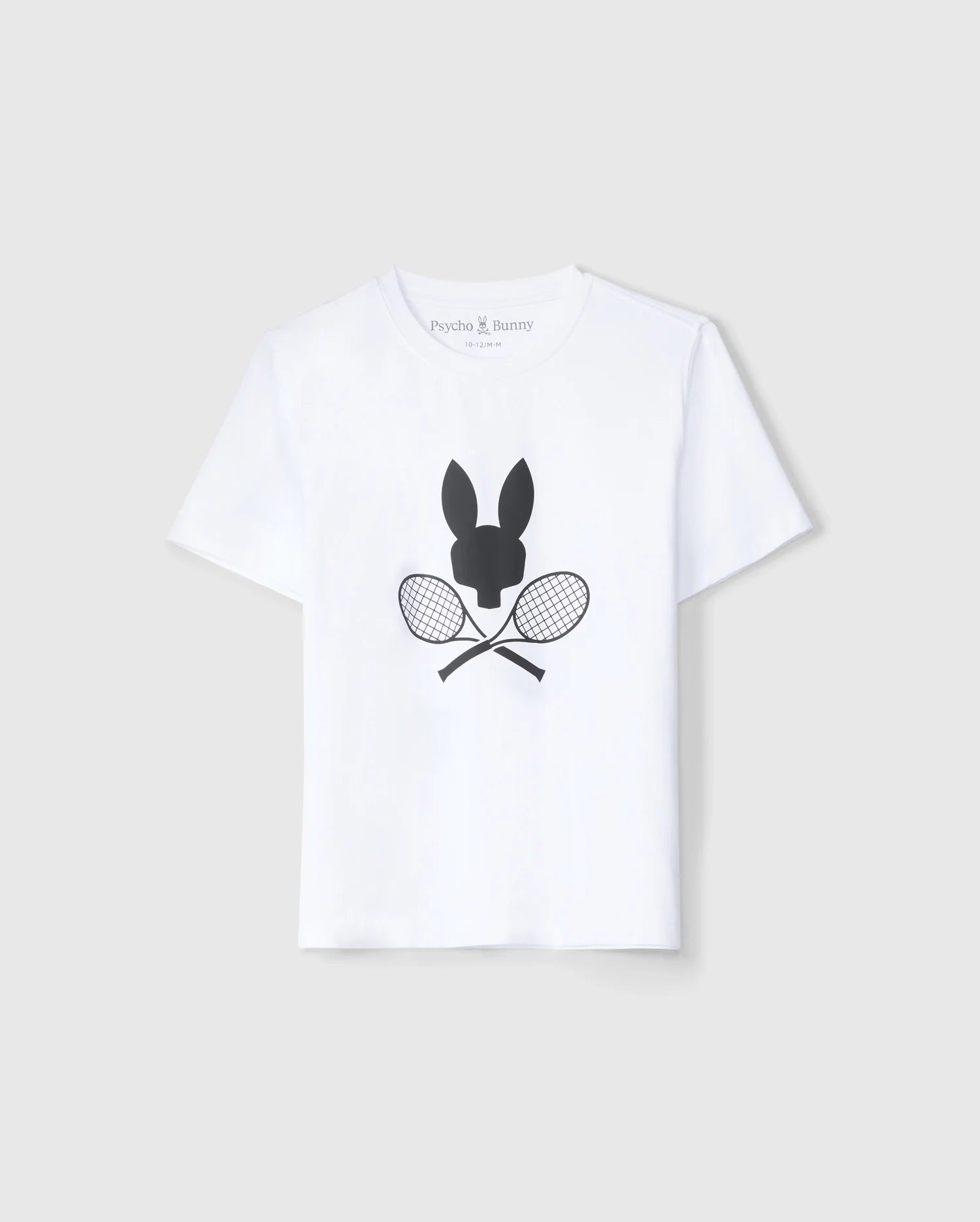 A white KIDS COURTSIDE GRAPHIC TEE - B0U681C200 featuring a black silhouette of a bunny's head above two crossed tennis rackets on the front. The brand name "Psycho Bunny" is printed on the inside neckline. This tennis-inspired t-shirt is displayed against a plain light grey background.