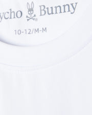Close-up image of the neck tag of a white Psycho Bunny KIDS COURTSIDE GRAPHIC TEE - B0U681C200, displaying the brand logo featuring a rabbit skull and crossbones. The sizes indicated are 10-12/M-M. The fabric appears smooth and well-stitched, perfect for a tennis-inspired look.