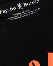 Close-up of the label on a black KIDS COURTSIDE GRAPHIC TEE - B0U682C200 by Psycho Bunny, showing size 10-12/M in white text. This kids' graphic tee boasts orange lettering on the front and is crafted from 100% pima cotton. Made in Peru, this tennis-inspired piece combines style and comfort.