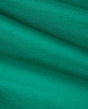Close-up of a green KIDS COURTSIDE GRAPHIC TEE - B0U684C200 by Psycho Bunny made from Pima cotton jersey fabric with smooth, slightly wavy folds. The texture appears soft and finely woven, creating gentle shadows and highlights that emphasize the material's flexibility and drape.