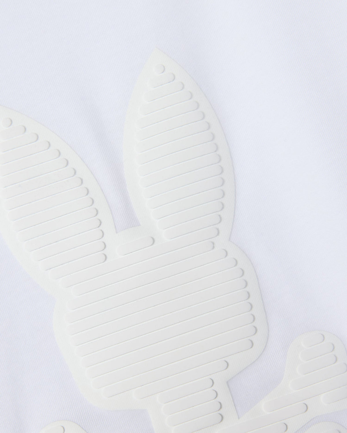 Close-up of a textured, abstract bunny graphic design on white Pima cotton. The Psycho Bunny Kids Kingston Graphic Tee (B0U743D200) showcases line details on the ears and body, giving it a modern, minimalist appearance.