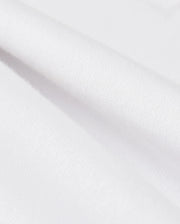 Close-up of smooth, white Pima cotton with soft folds, highlighting the clean texture of a Psycho Bunny KIDS LONDON RAGLAN GRAPHIC TEE - B0U896D200.