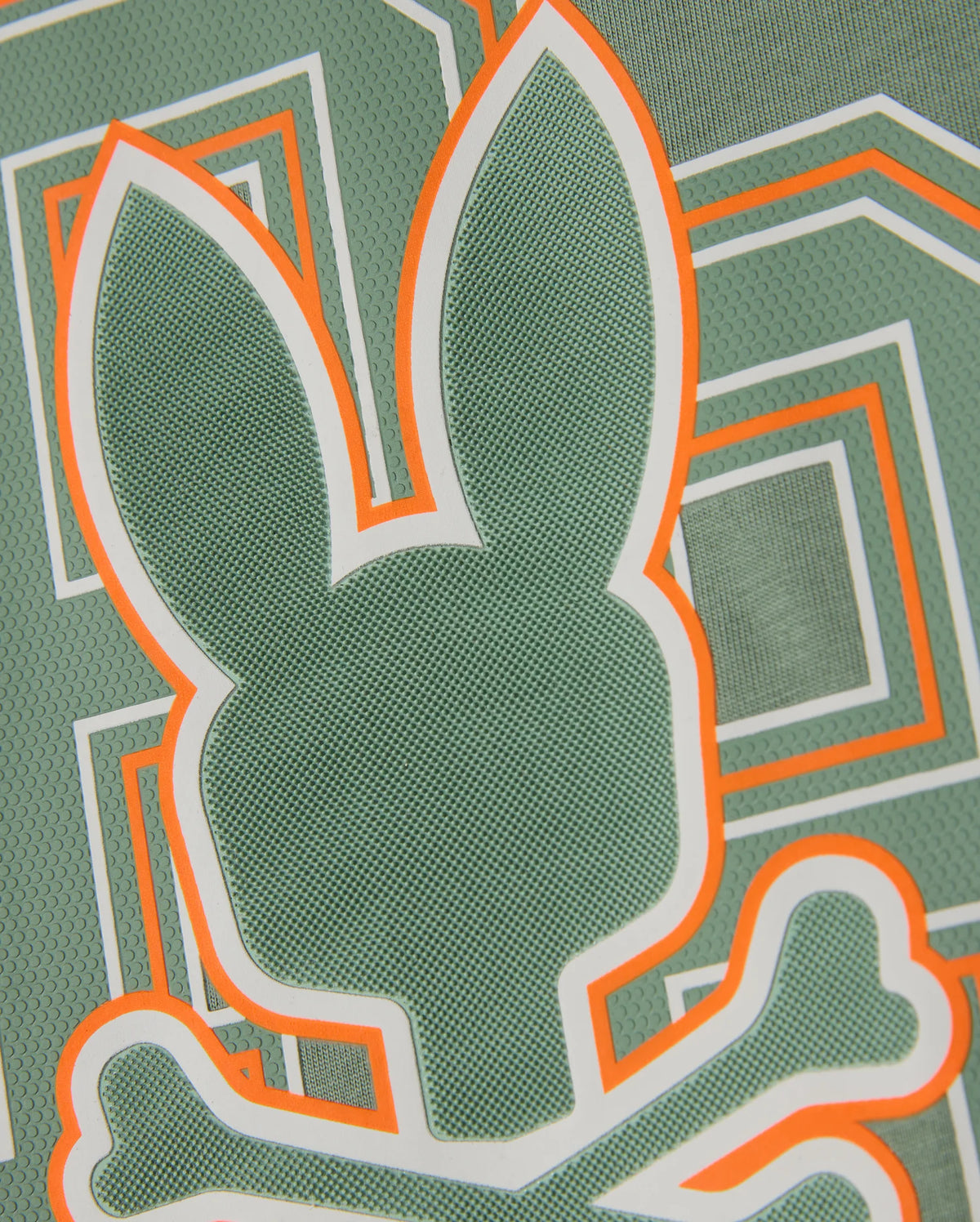 The KIDS ZACK GRAPHIC TEE - B0U897D200 by Psycho Bunny features a green pattern that highlights the iconic Psycho Bunny head with crossbones underneath. Accented with orange and white lines, its geometric background is crafted from soft Pima cotton, combining bold style with comfort.