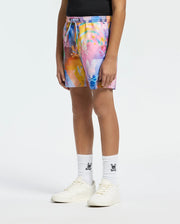 psycho bunny swim trunks with a vibrant geometric bunny skull print in pink, blue, yellow, and orange, featuring a drawstring waist and the iconic bunny skull logo on white socks.