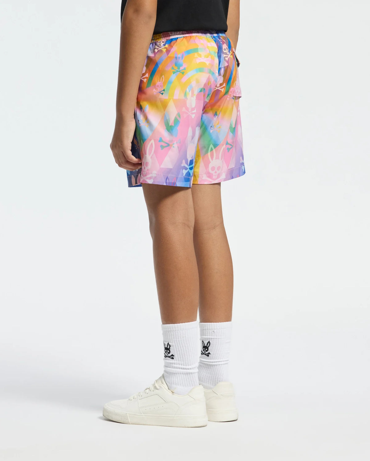 Psycho Bunny swim trunks with a vibrant, multicolored diamond pattern featuring the bunny skull logo, relaxed fit, and a small logo on white socks.