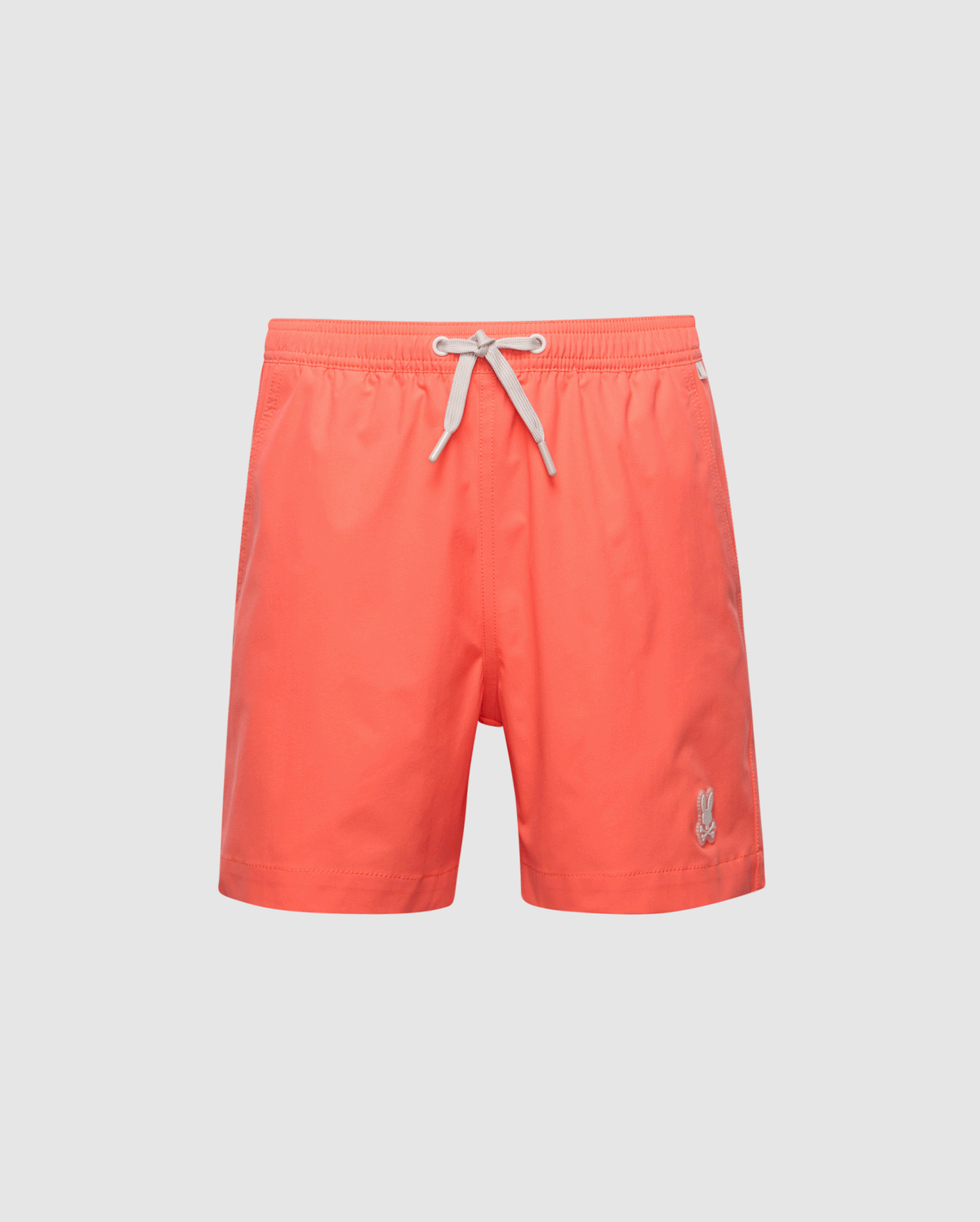 The Psycho Bunny KIDS SAMOS HYDROCHROMIC SWIM TRUNK - B0W453F200 features bright coral color, a white drawstring waistband, and an embroidered logo on the lower left. These quick-dry swim trunks offer a classic design perfect for the beach or pool.
