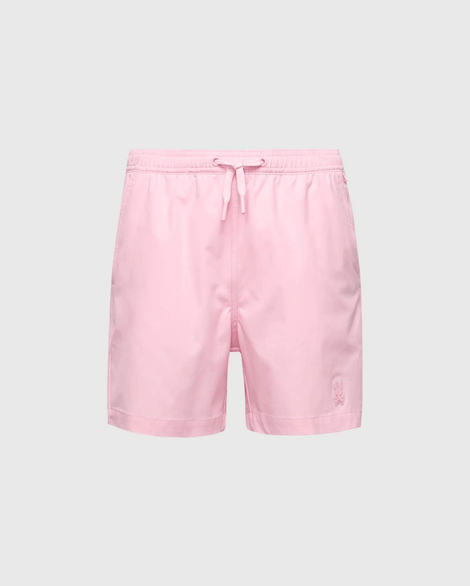 The Psycho Bunny KIDS SAMOS HYDROCHROMIC PRINTED SWIM TRUNK (B0W453F200) features light pink material with an elastic waistband, adjustable drawstring, and a small logo embroidered on the lower left leg. The solid gray background enhances their sleek and stylish look.