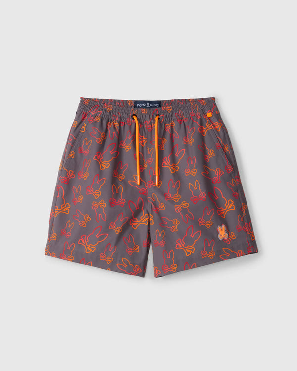 Gray kid's swim trunks featuring an all-over playful bunny pattern in orange and red outlines. These shorts have a quick-dry fabric, an elastic waistband with a bright orange drawstring, and a navy label on the waistband. The trunks are the KIDS SHELDON ALL OVER PRINT SWIM TRUNK - B0W588C200 by Psycho Bunny.