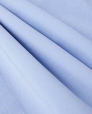 Close-up of Psycho Bunny's KIDS MELVIN SWIM TRUNK - B0W665C200: a light blue, quick-dry fabric with diagonal folds and a smooth, slightly shiny texture that creates wave-like patterns perfect for swimwear.