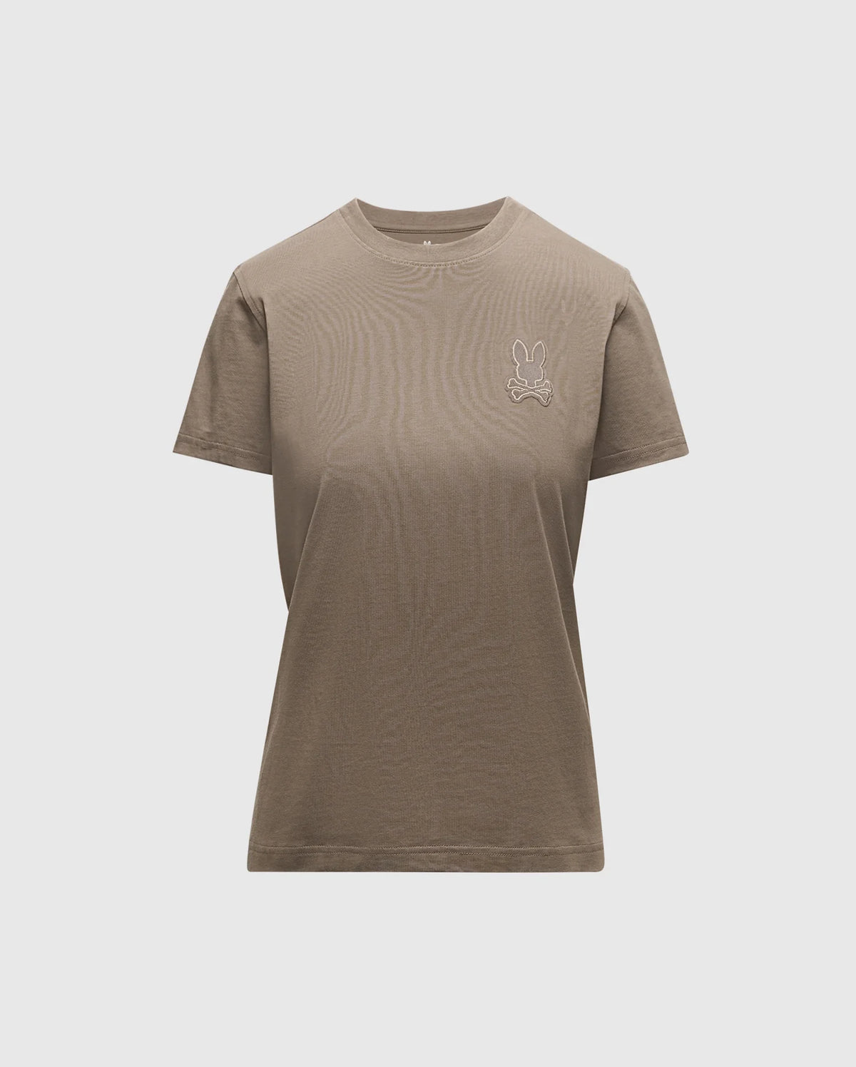 Introducing the WOMENS ALEXANDER GRAPHIC TEE by Psycho Bunny, a classic plain brown tee made from luxurious Pima cotton. It showcases a subtle Lurex embroidered bunny logo on the upper left side. Designed with a round neckline and short sleeves, this piece offers comfort and style with its light grey backdrop.