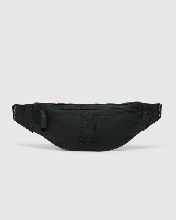 The Psycho Bunny MENS CROSS BODY BAG - B6A181E200 is a black waist pouch with a zipper, showcasing an embossed bunny and crossbones design on the front. This stylish cross body bag includes an adjustable strap and a minimalist aesthetic, ideal for those who desire chic utility on a plain background.