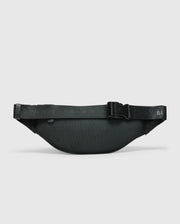 The MENS CROSS BODY BAG - B6A181E200 by Psycho Bunny is a black waist bag with an adjustable strap and a sleek, minimalist design. This functional cross body bag features a buckle closure, and its textured pattern stands out against the plain white background.