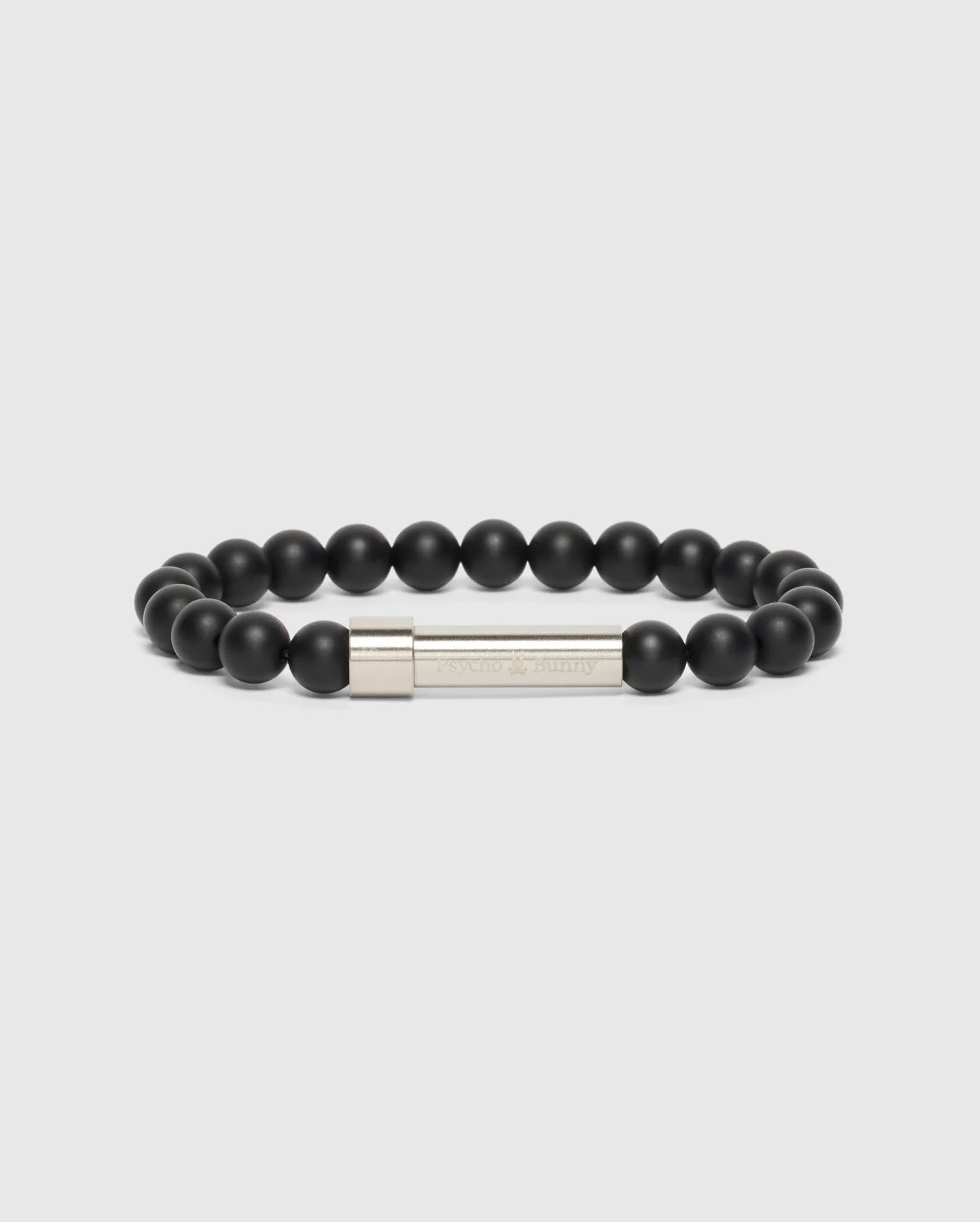 The Psycho Bunny MEN'S BEAD BRACELET - B6A370E200 features a high-quality beaded design, complete with a silver clasp engraved with text. Arranged in a circular shape on a light gray background, it makes the perfect fashion accessory.