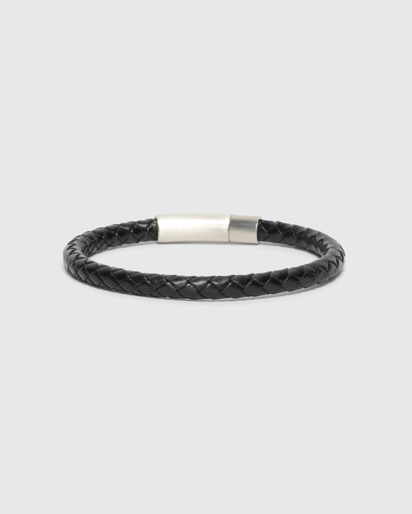 The Psycho Bunny Men's Braided Leather Bracelet (B6A371E200) in sleek black, features a silver clasp and combines durability with style against a neutral backdrop.