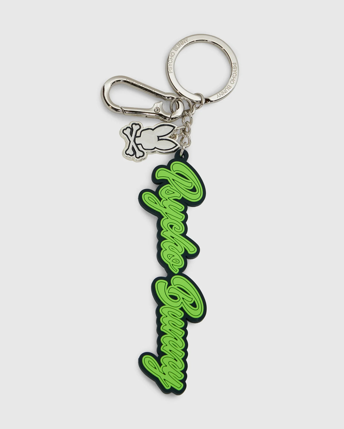 This Psycho Bunny silicone keychain, model B6A373E200, displays the text "Angels Bunny" in elegant green script on a silver keyring with a lobster clasp. It includes an extra charm of a bunny outline, combining practicality with a chic design.