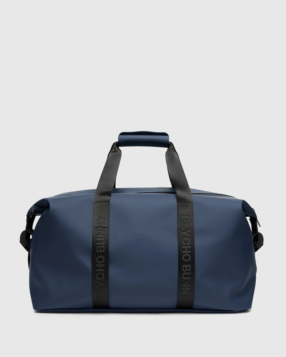 A sleek, blue mens duffle bag (B6A472F200) from Psycho Bunny sits against a gray backdrop. It features black handles and shoulder strap, with "PSYCHO BUNNY" emblazoned on the quality handles.