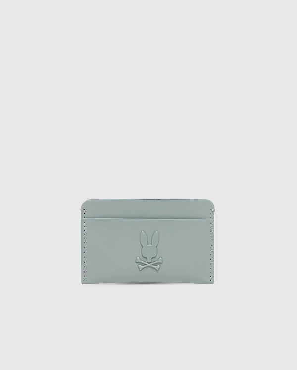 The "MENS RUBBERIZED CARD CASE - B6A473F200" by Psycho Bunny is a minimalist, light gray wallet featuring a subtle rabbit and crossbones embossment and edge stitch details for secure storage.