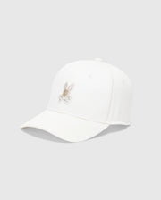 The Psycho Bunny MENS NEW CASTLE GRAPHIC BASEBALL CAP - B6A547F200, with a light brown rabbit embroidered on white cotton twill, exudes quiet luxury. Its slightly curved brim stands out artfully against a plain gray background.