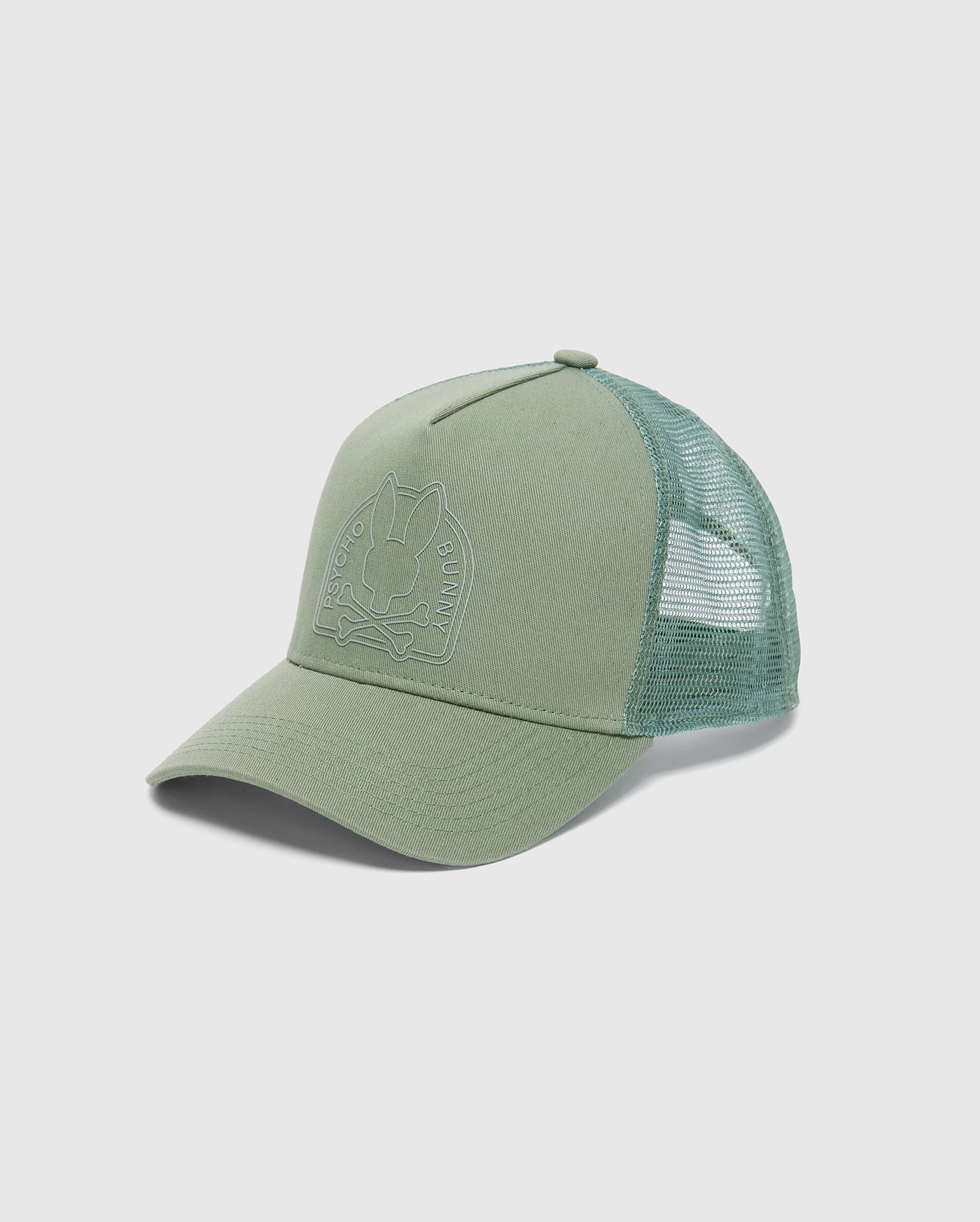 Introducing the Psycho Bunny MENS MELBOURNE GRAPHIC TRUCKER HAT - B6A548F200: a stylish green cap with an embroidered bunny above crossed bones on the front panel. Its mesh back ensures breathability, and the curved brim with adjustable strap makes it ideal for any outing.