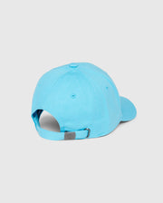 The Psycho Bunny MENS LOUISE BASEBALL CAP - B6A551C200, crafted from light blue cotton twill, is displayed from the back. This cap features a curved brim, a button on top, and ventilation eyelets. An embroidered logo adorns the front while an adjustable strap with a metal clasp at the back ensures a perfect fit.