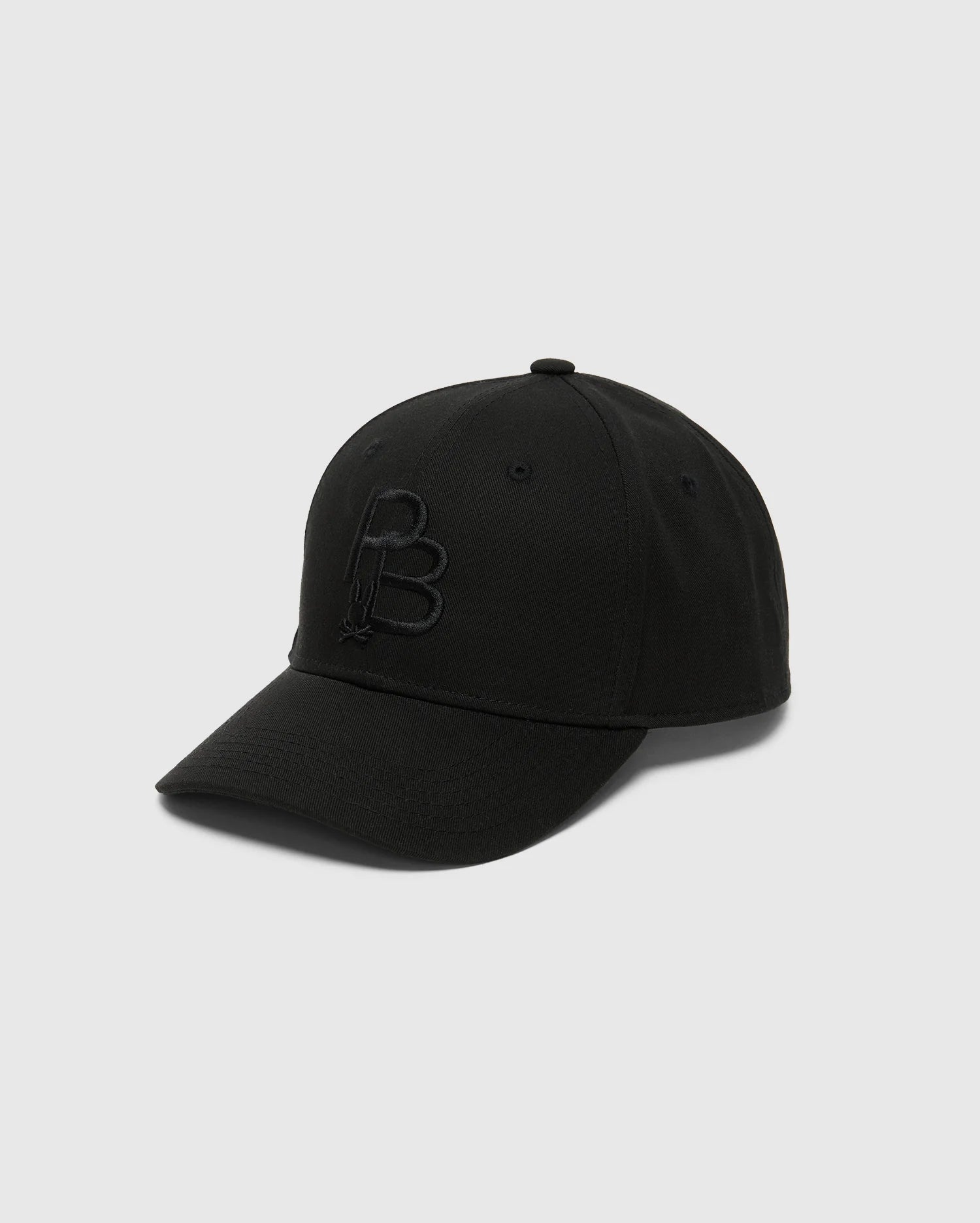 The Psycho Bunny MENS NICHOLSON cap (B6A553F200) features a cotton twill design with an embossed "B" logo on the front, adjustable backstrap, and light gray background, showcasing its stylish front and side views.