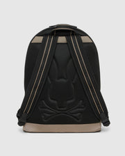 A stylish black urban backpack with a subtle rabbit and crossbones design embossed on the back panel. The straps are black with beige accents, and the base is beige. With a sleek, modern appearance and a padded laptop compartment, this Psycho Bunny MENS DOME BACKPACK - B6A628Z1BP blends functionality with unique style seamlessly.